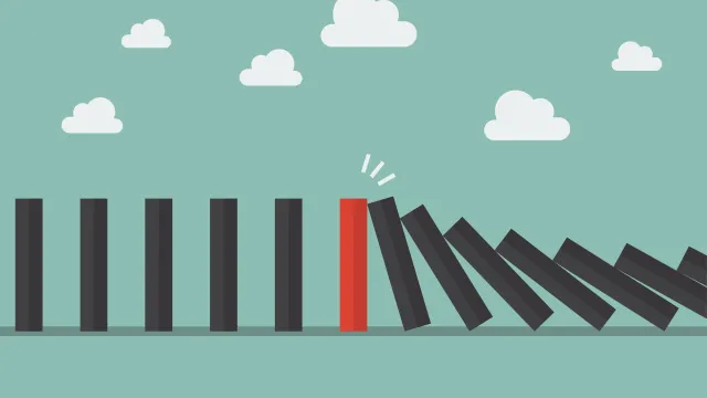 Red domino among many black dominoes falling over in a chain reaction